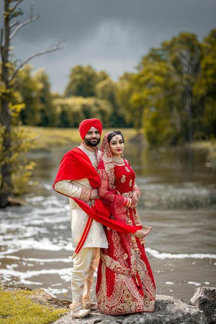 Sikh groom and bride by a river
