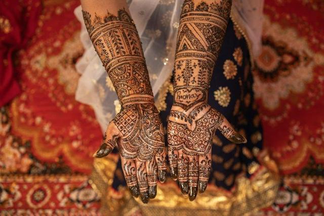 Bride showing mehendi on her hands